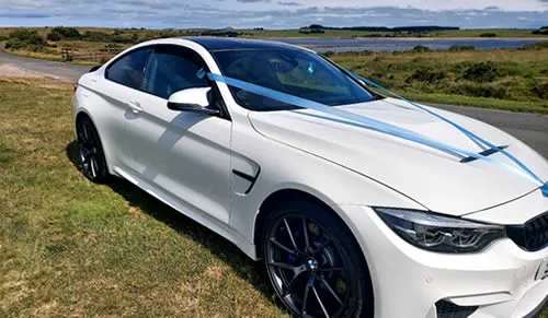 BMW M4 angled three-quarter view.