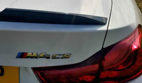 BMW M4 rear quarter showing M-badged rear diffuser.